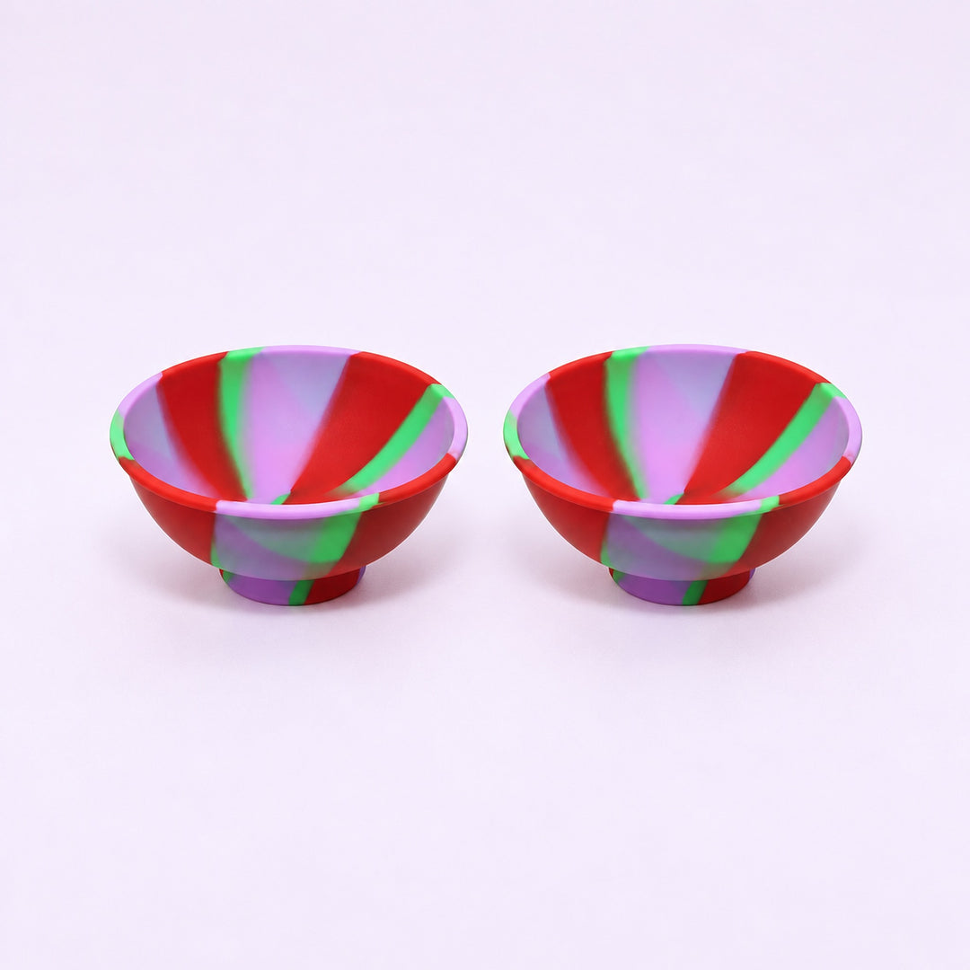 Two red purple and green swirl silicone mini bowls, open tops and pedestal bases.