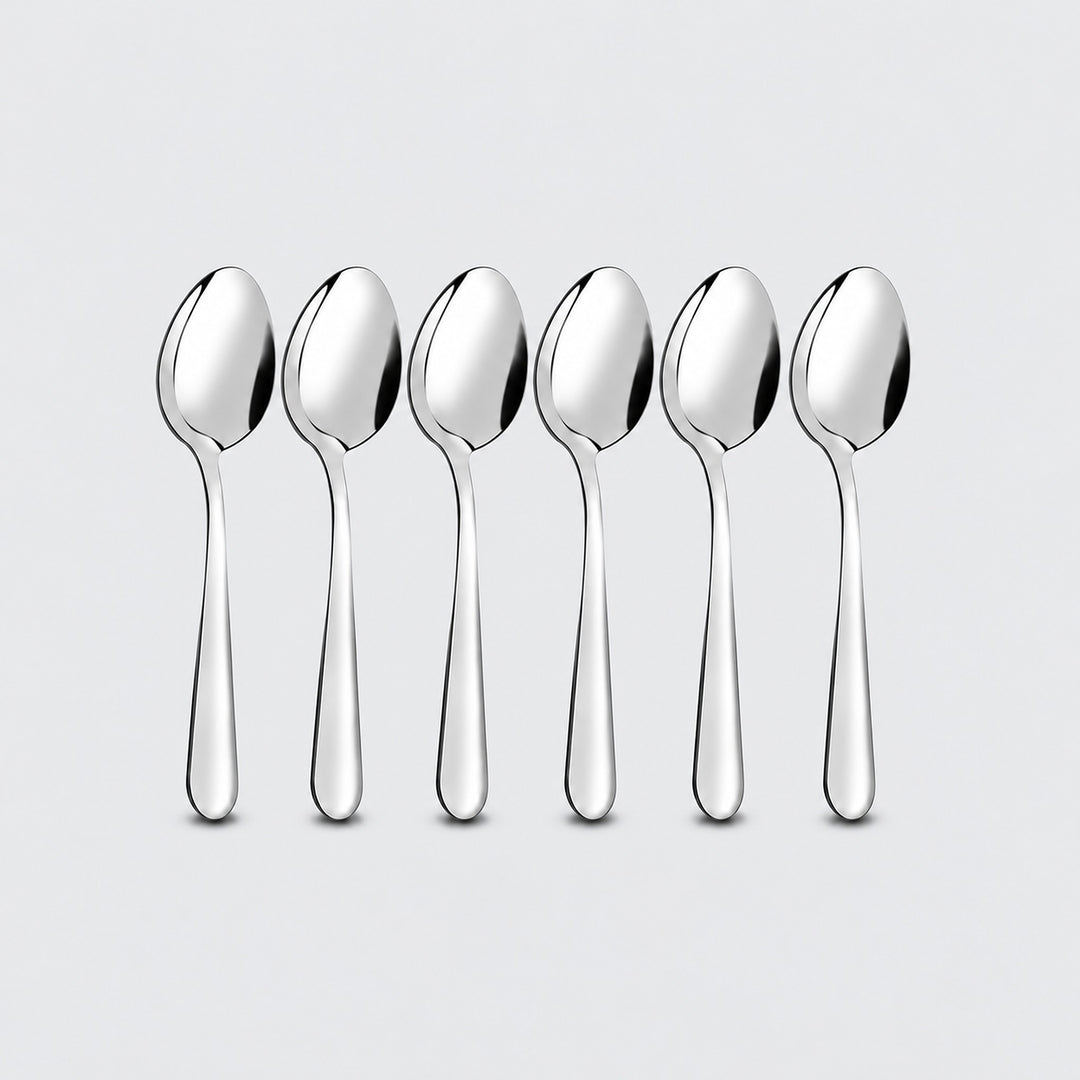 Six silver teaspoons on a pale gray studio background.
