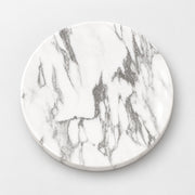 A round white marble coaster with elegant gray veining, shown from a top-down perspective on a light gray background.