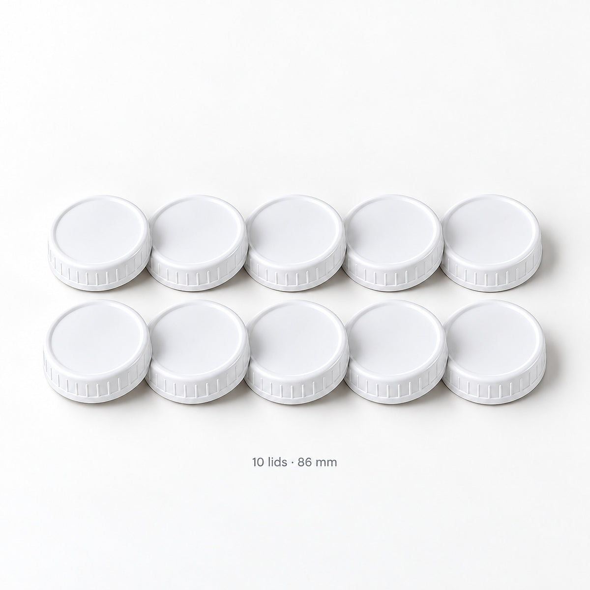 Set of ten white 86 mm ribbed plastic mason jar lids.