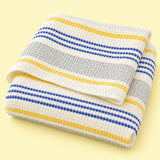 Yellow striped waffle cotton towel on pale yellow studio background; size selected separately.