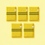 Yellow variant: five yellow exfoliating mitts with white side tabs on a pale yellow background.