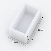 A white rectangular open-top mold or tray shown on a light gray background with dimension arrows and labels indicating 2.8 cm, 2.