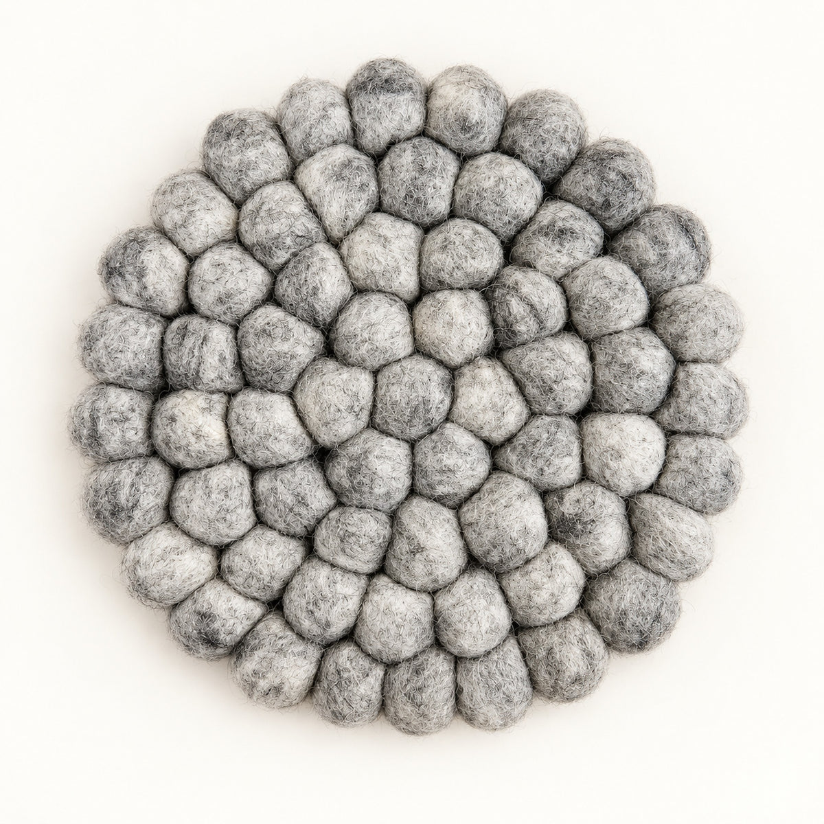 A round felt mat made of small gray pom-poms, photographed from directly above on a plain white background.
