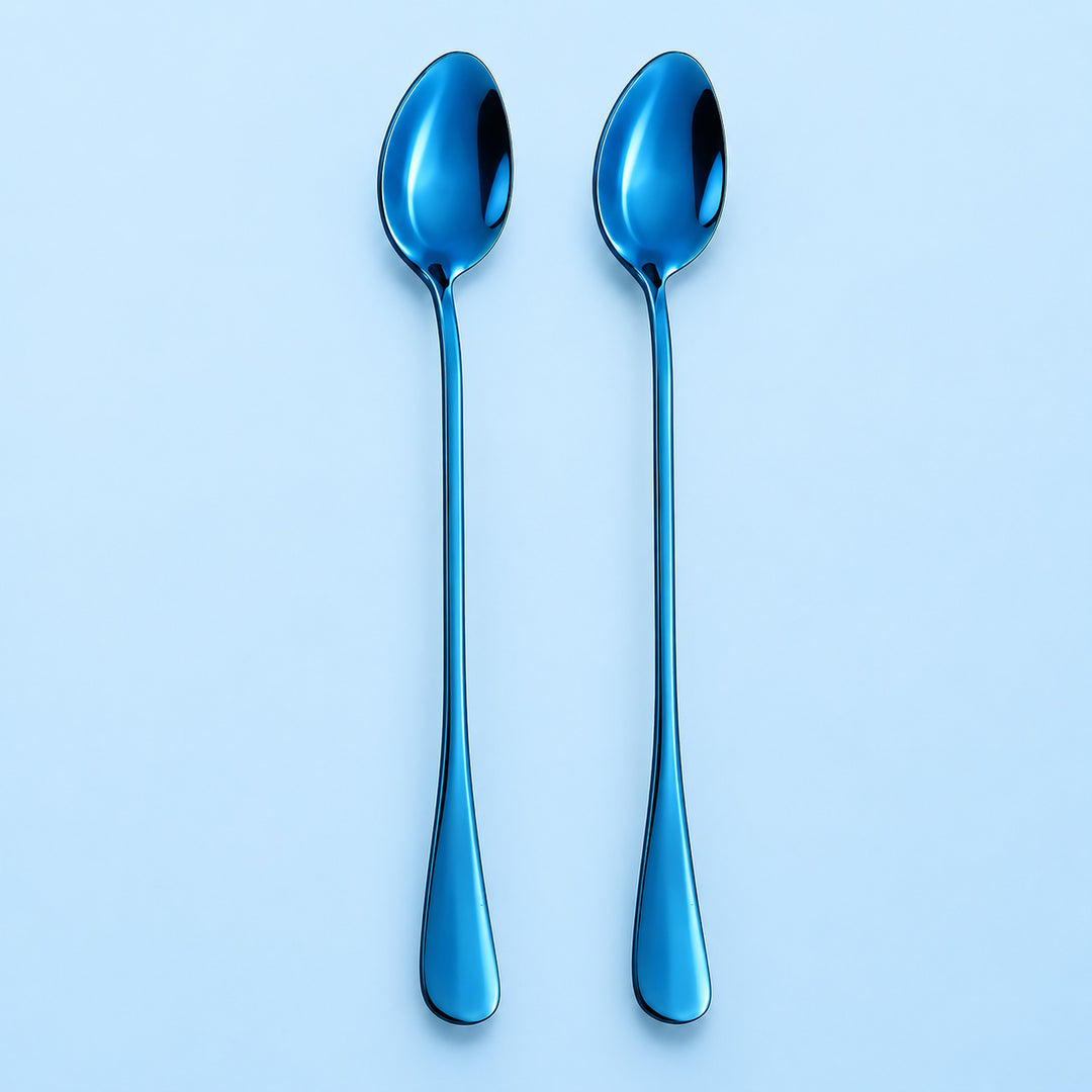 Two metallic blue spoons with a reflective finish, standing vertically side-by-side on a light blue background.