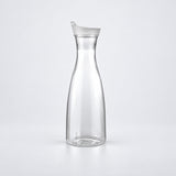 Empty 1000 ml clear plastic carafe with white lid.
