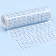 A roll of clear adhesive grid tape with blue lines, partially unrolled on a light blue background.