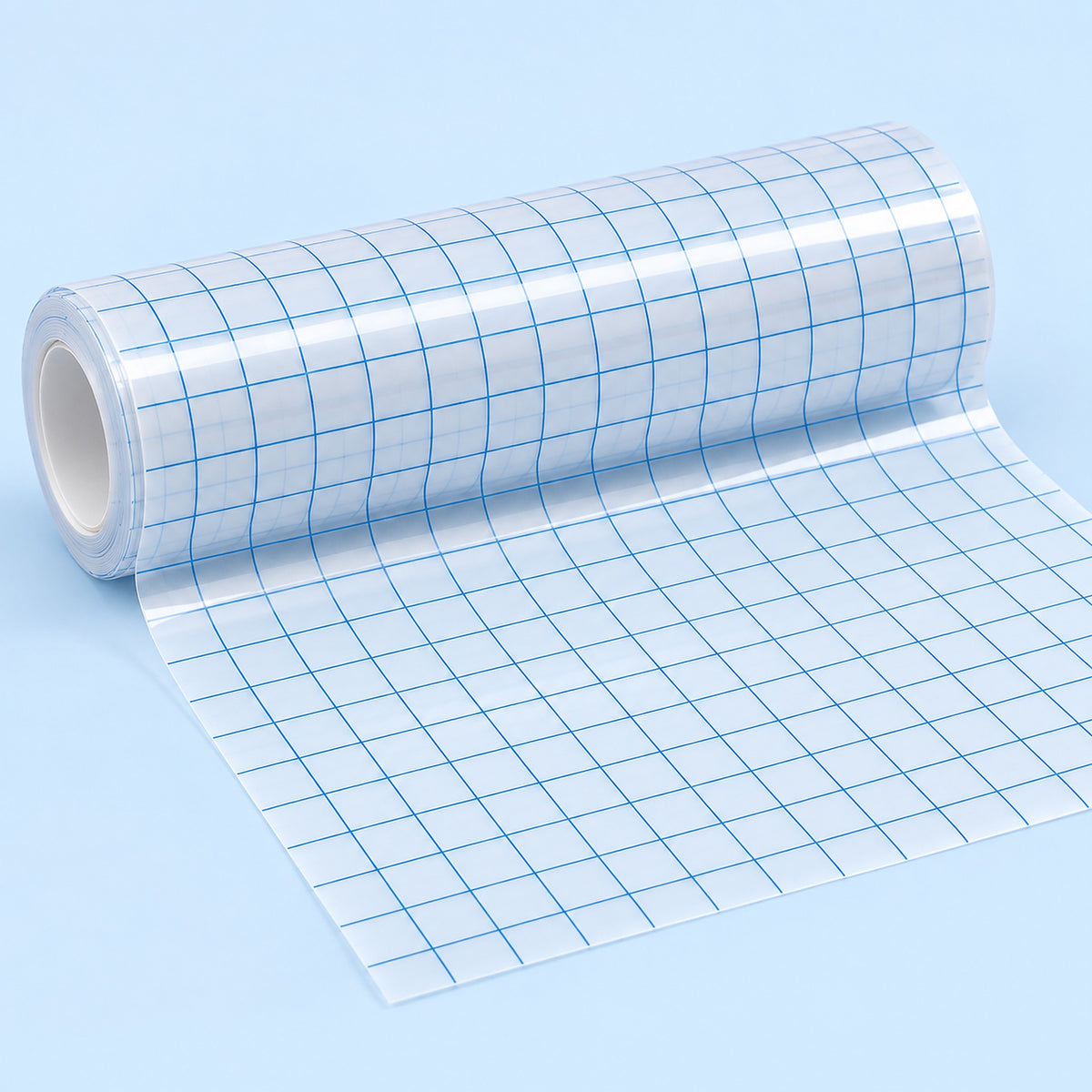 A roll of clear adhesive grid tape with blue lines, partially unrolled on a light blue background.