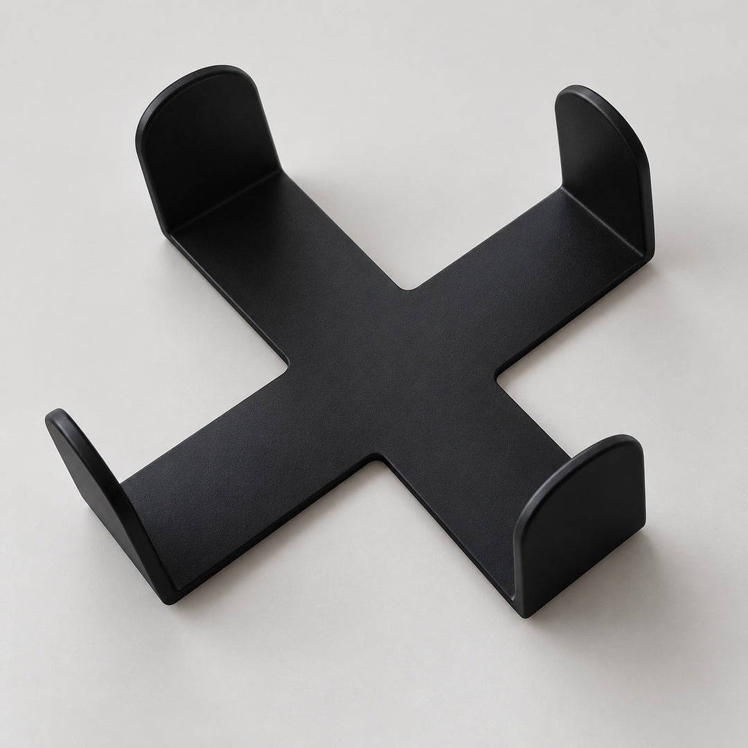 One empty black cross-shaped coaster holder, coasters sold separately.