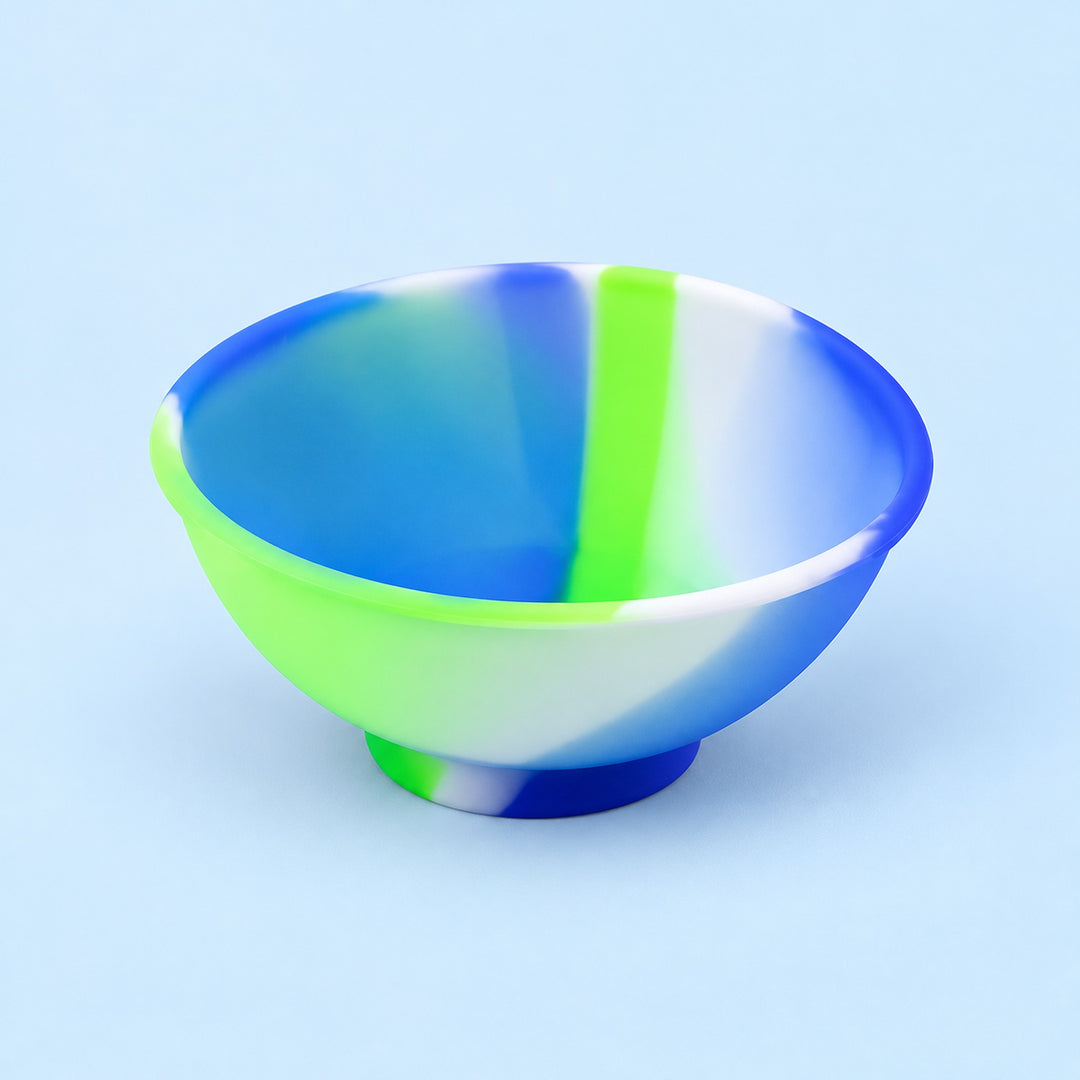 Blue, green and white mini silicone bowl, single empty piece in studio.