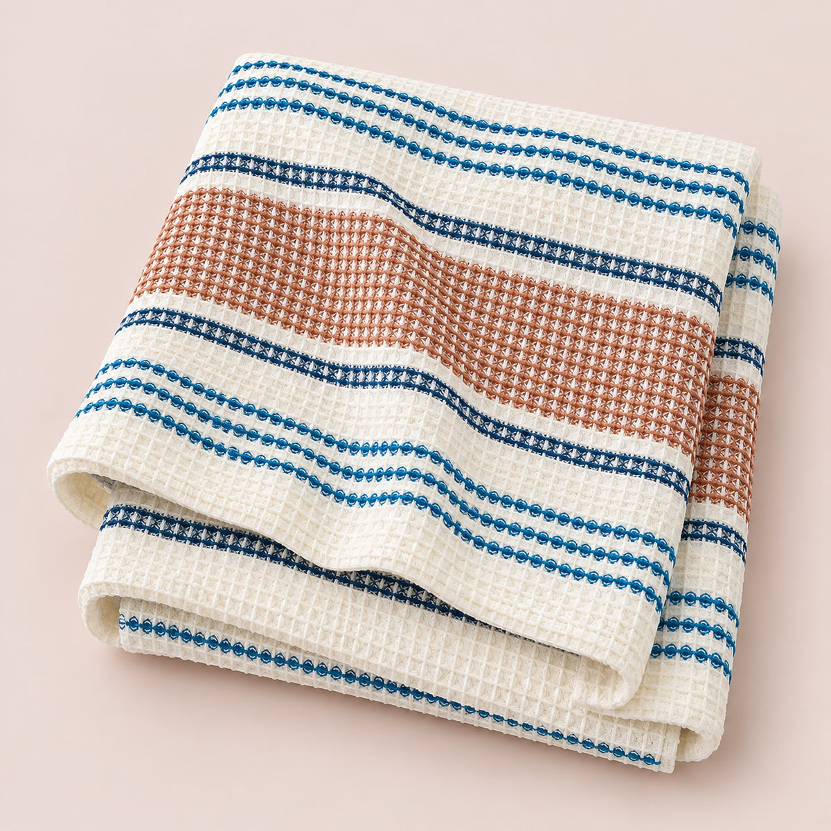 Coffee striped waffle cotton towel on pale rose-brown studio background; size selected separately.