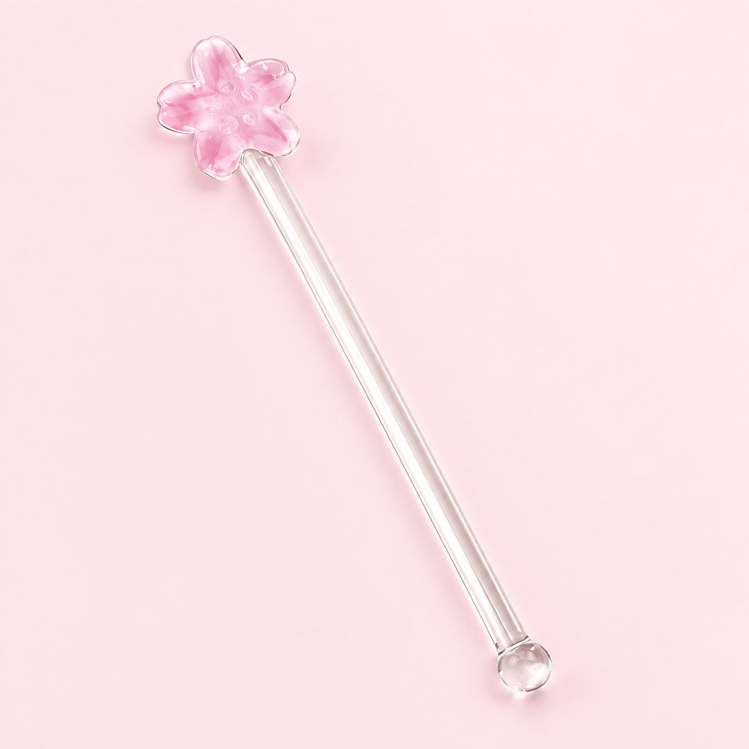One pink Flower glass stirrer, approximately 12.5 cm long, on pale pink studio background.