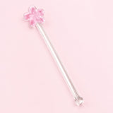 One pink Flower glass stirrer, approximately 12.5 cm long, on pale pink studio background.