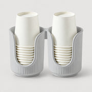 A two-pack of white paper cups stacked inside ribbed gray cup holders, shown on a light gray background.