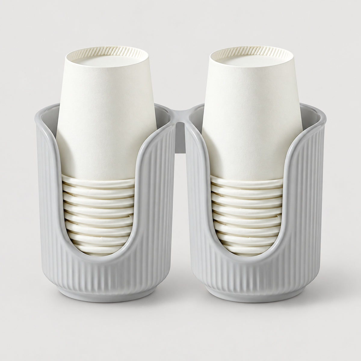 A two-pack of white paper cups stacked inside ribbed gray cup holders, shown on a light gray background.