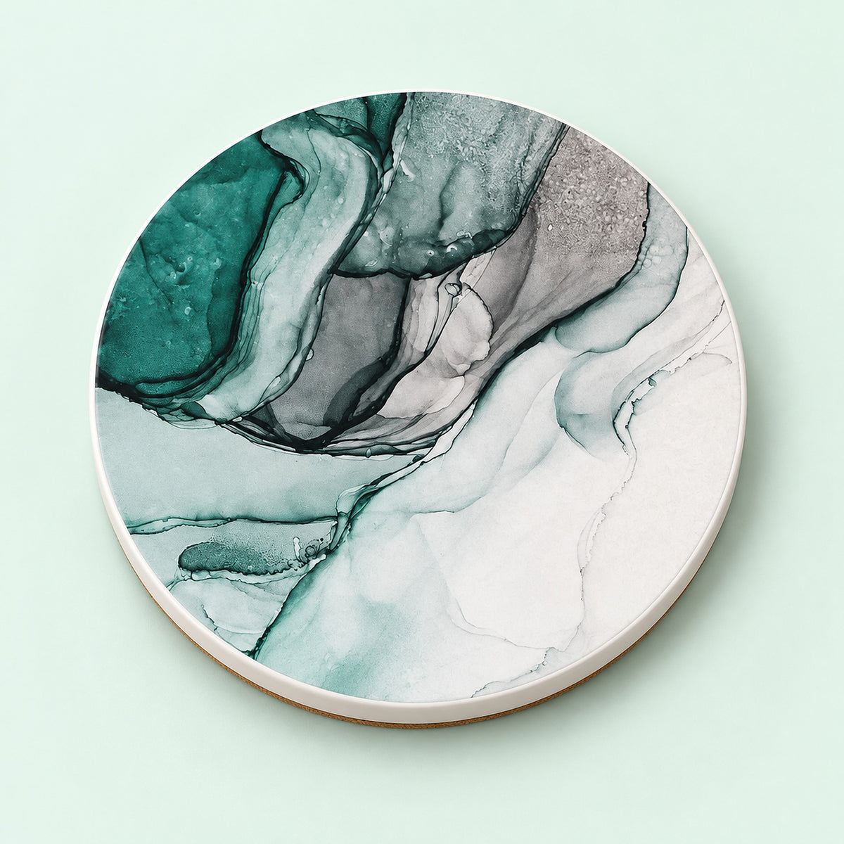 One green and white marble waves printed ceramic coaster on a light studio background.