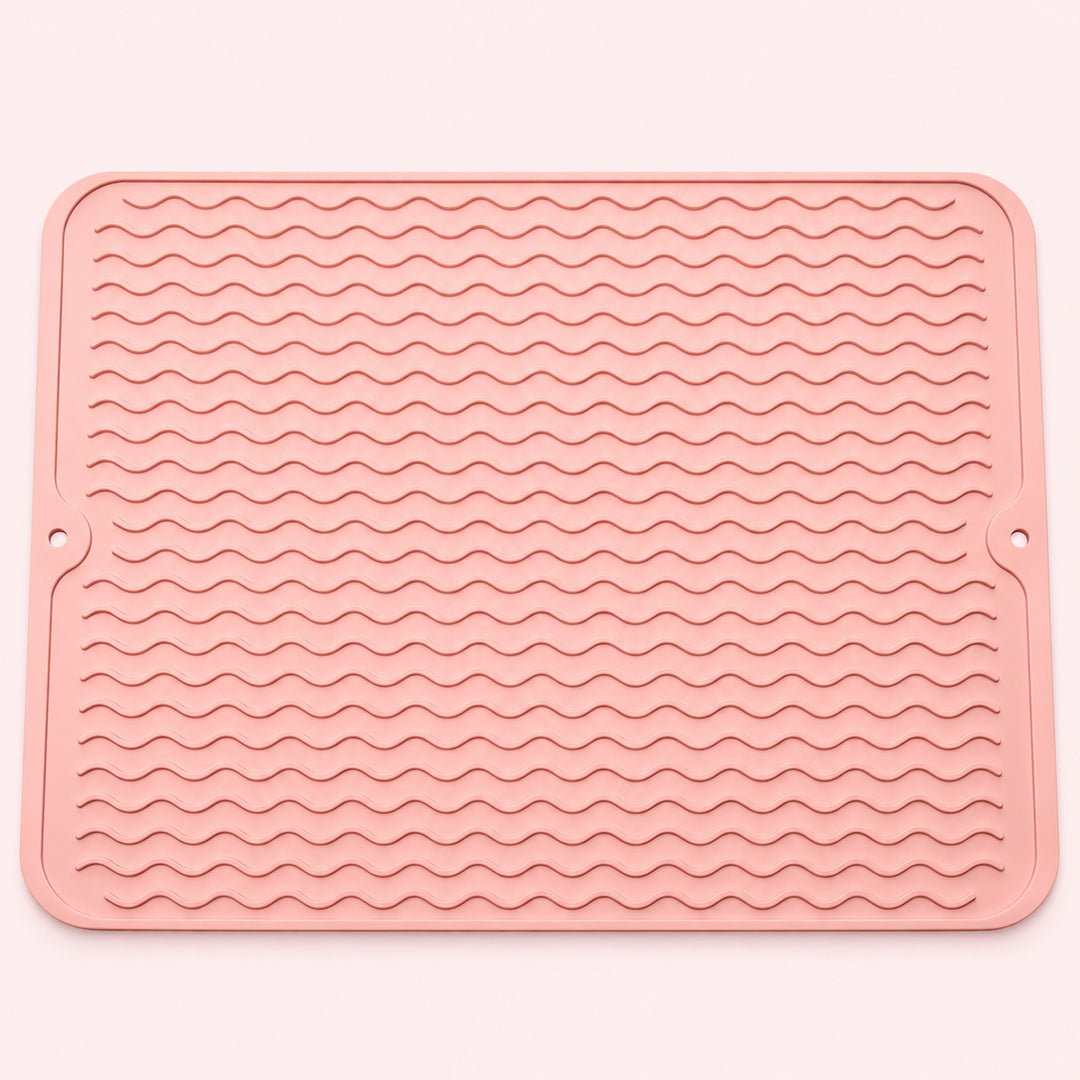 Pink wavy-ridge silicone mat with two hanging holes.