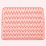 Pink wavy-ridge silicone mat with two hanging holes.