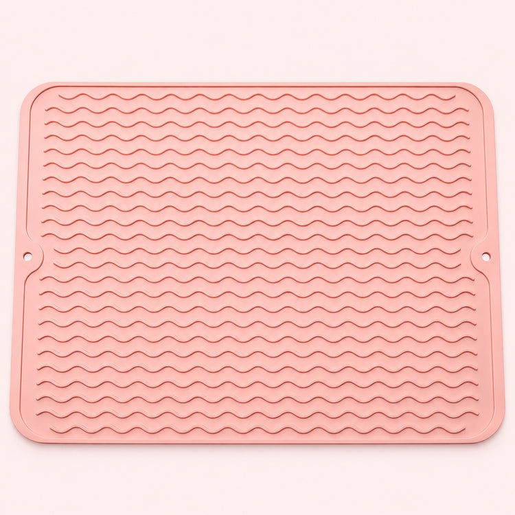 Pink wavy-ridge silicone mat with two hanging holes.