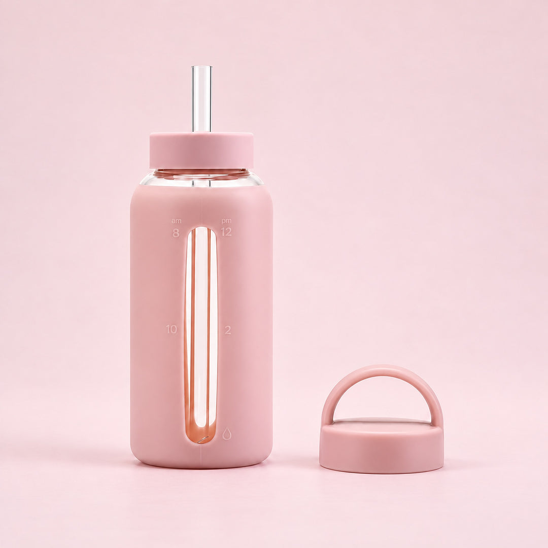 Pink 800 ml glass bottle with silicone sleeve, wide straw and spare loop lid.