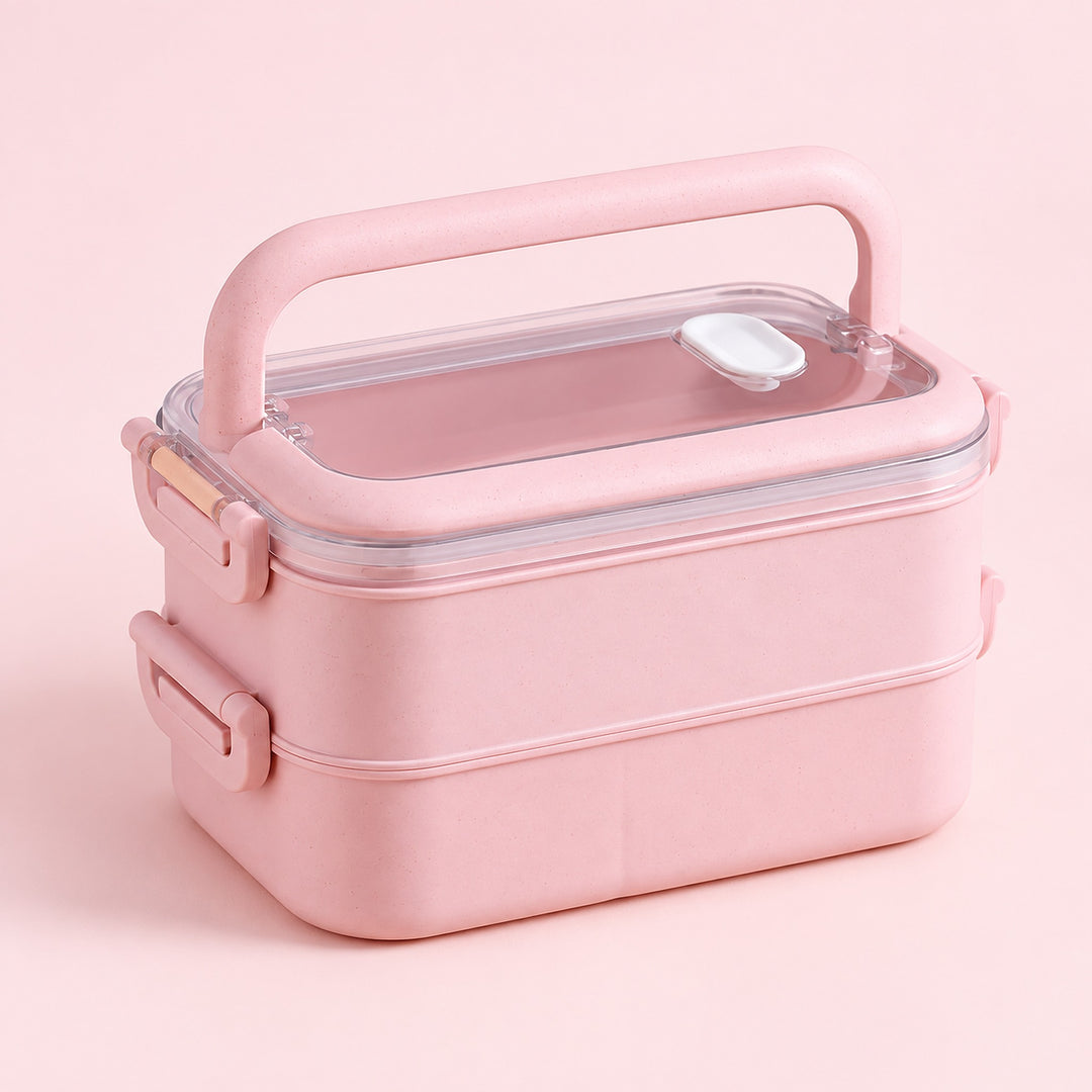 pink double layer plastic bento lunchbox with clear lid and carry handle.