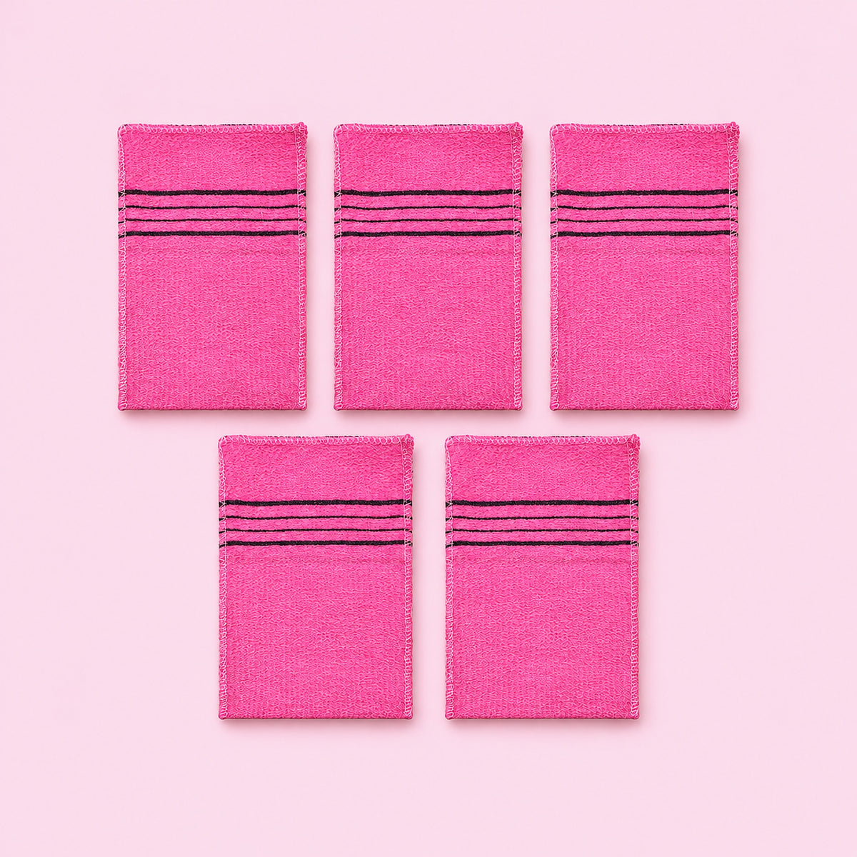 Pink variant: five pink rectangular exfoliating mitts on a lighter pink studio background.