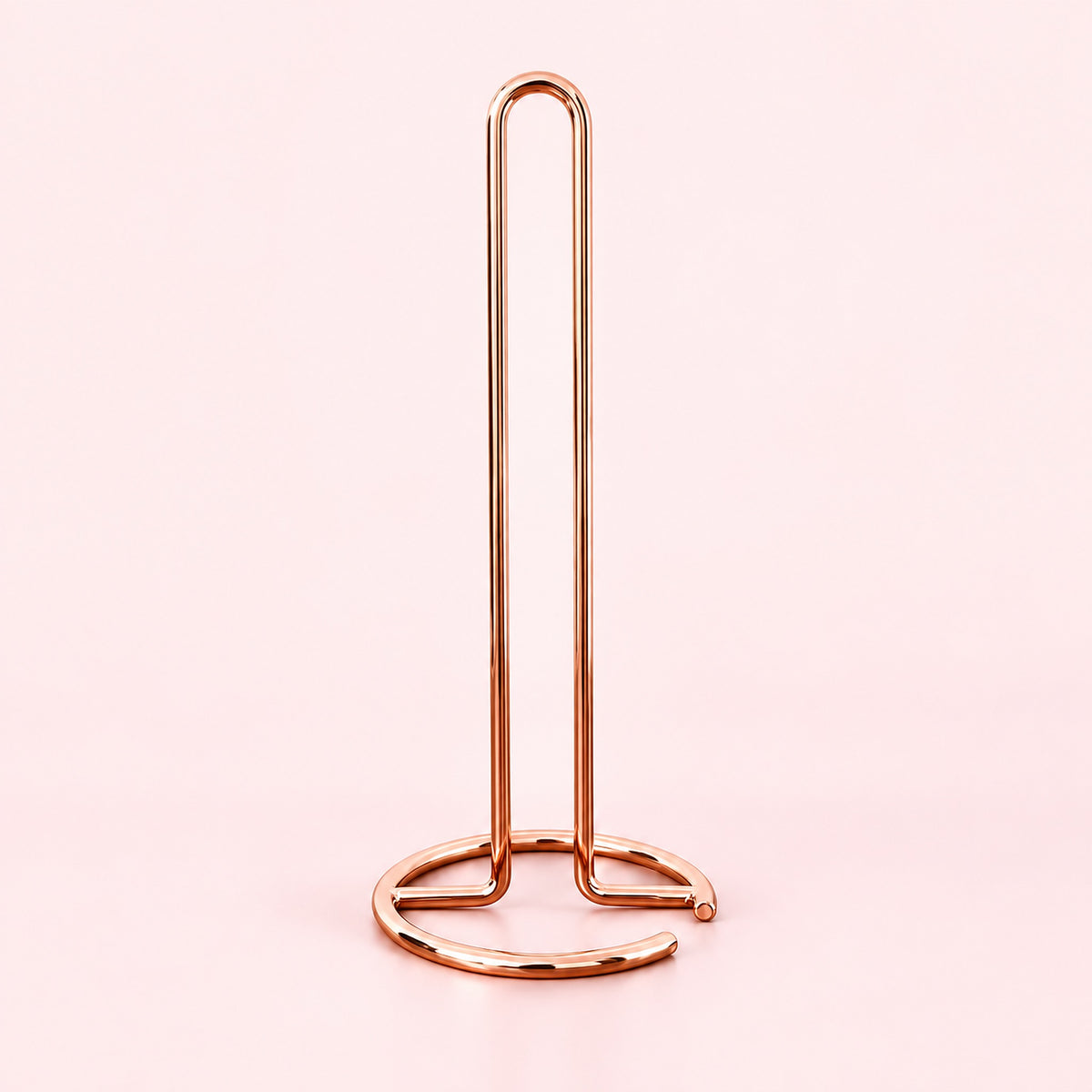 Empty rose-gold upright paper towel stand with open wire base.