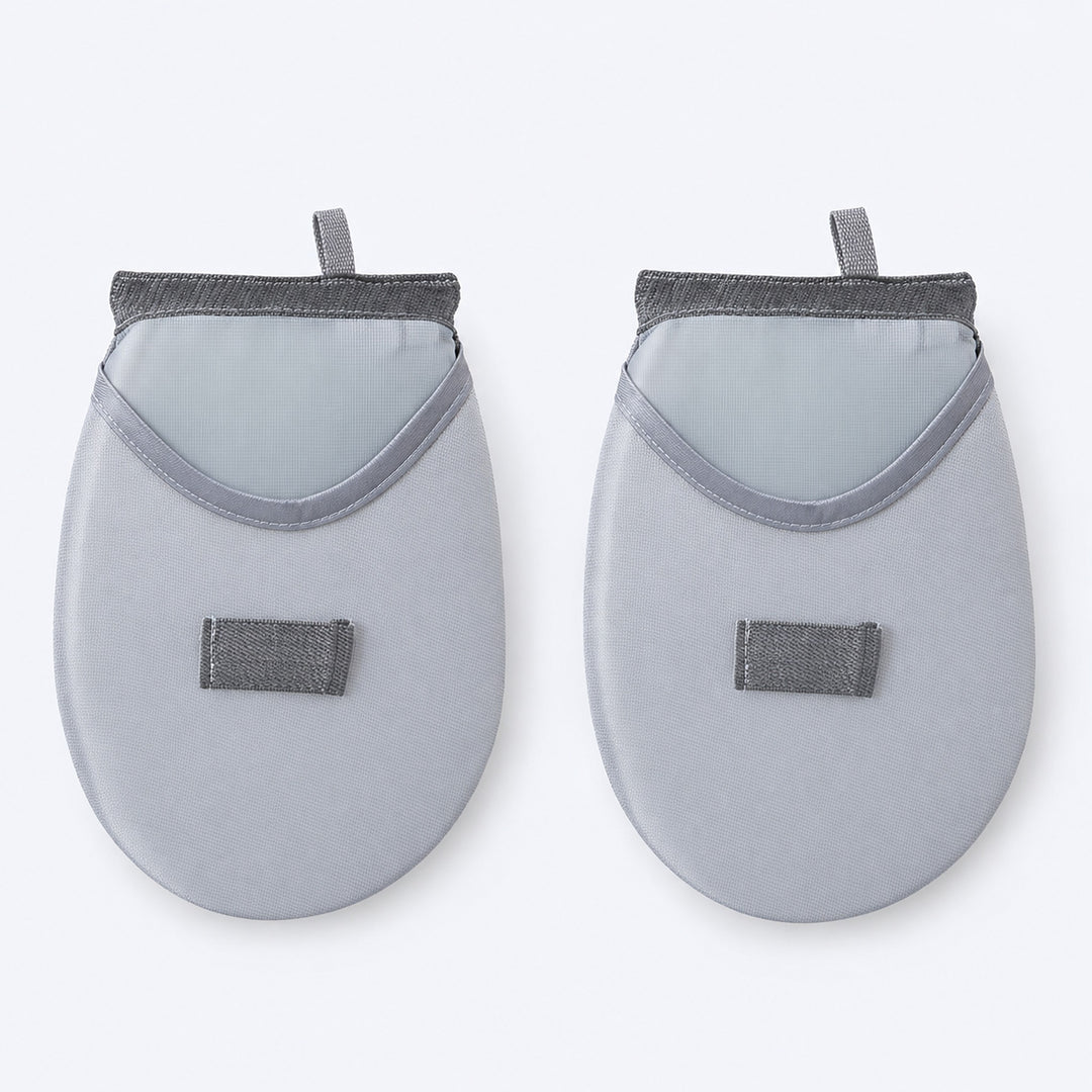 Two rounded garment-steaming pads with mesh hand pockets.