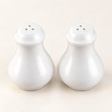 A pair of glossy white ceramic salt and pepper shakers with three-hole tops, set against a plain off-white background.