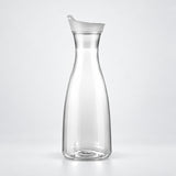 Empty 1400 ml clear plastic carafe with white lid.