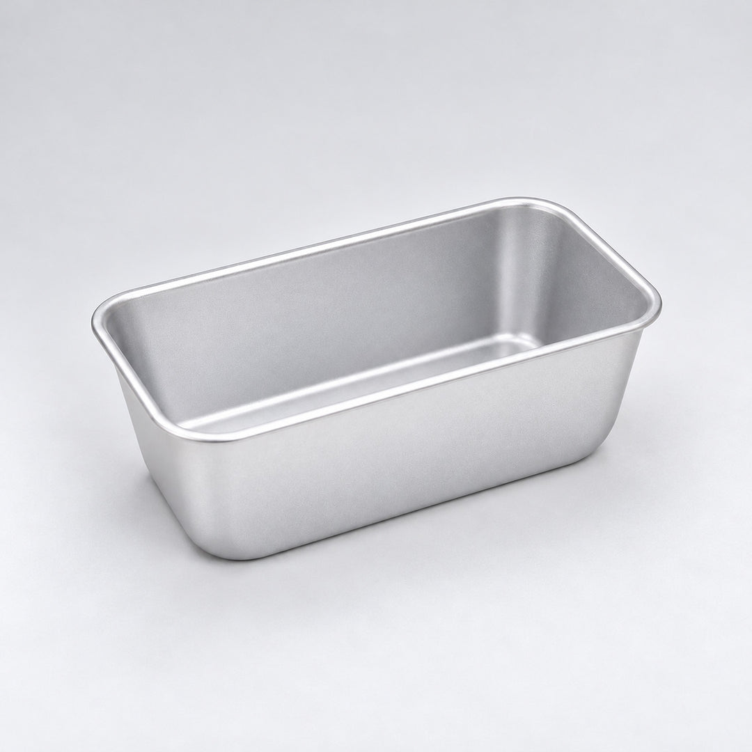 Empty silver aluminum loaf pan, 16.3 x 9.8 x 6.7 cm.