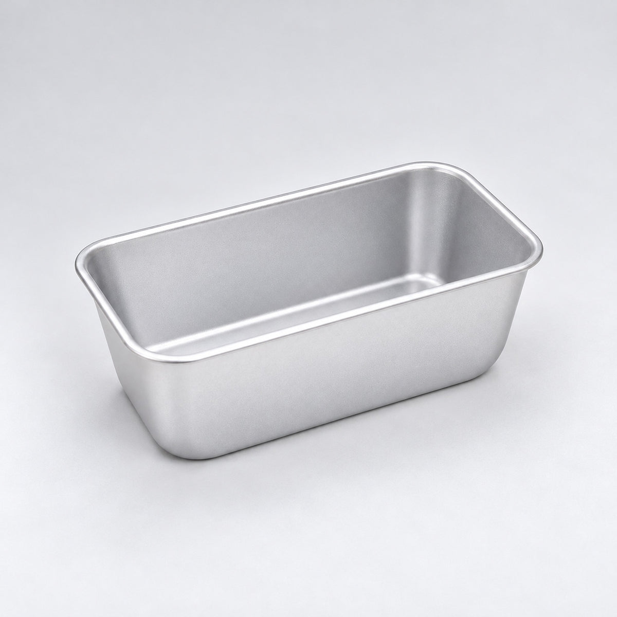 Empty silver aluminum loaf pan, 16.3 x 9.8 x 6.7 cm.