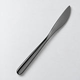 One black dinner knife on a soft studio background.