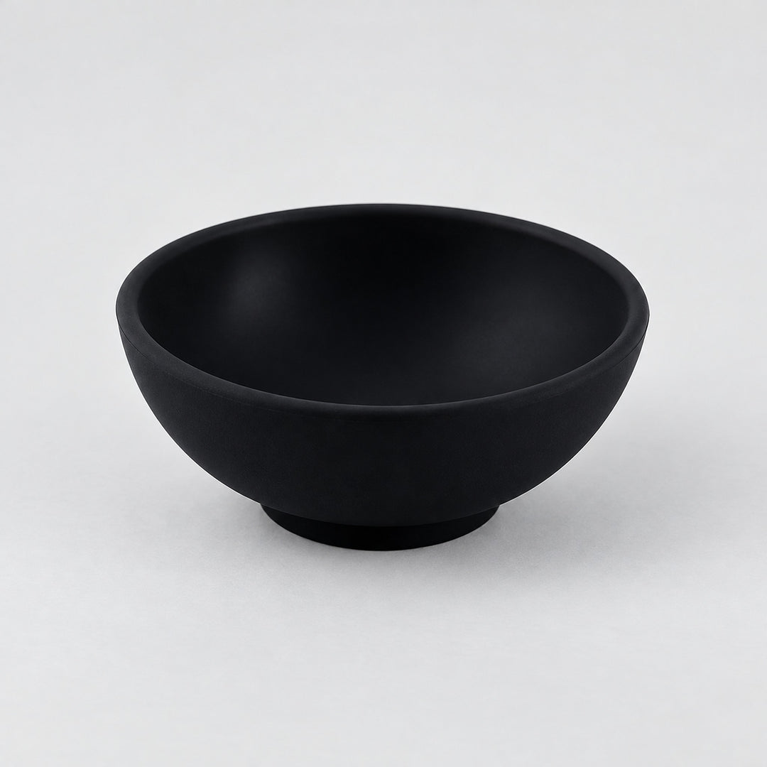 Black mini silicone bowl, single empty piece in studio.