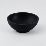 Black mini silicone bowl, single empty piece in studio.
