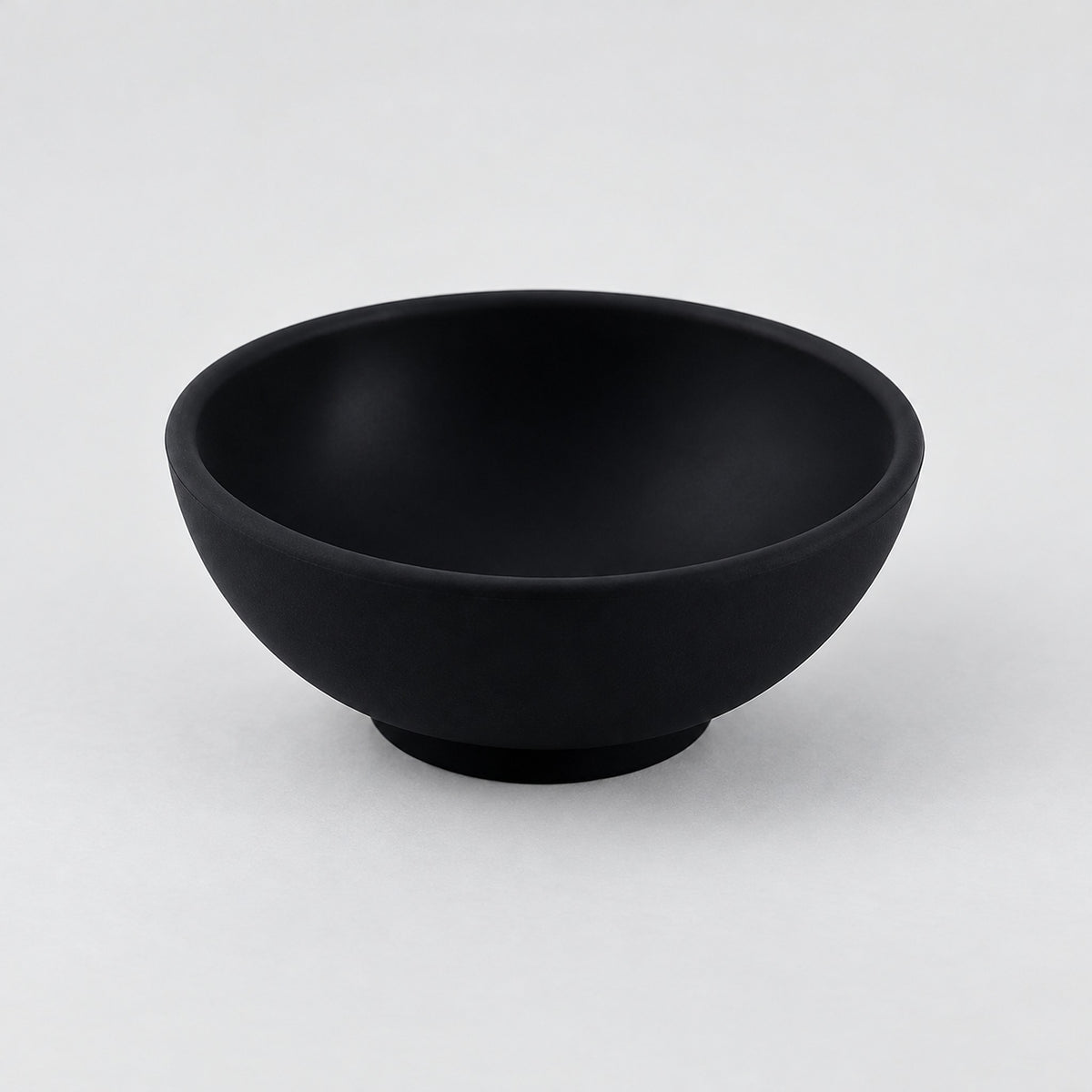 Black mini silicone bowl, single empty piece in studio.