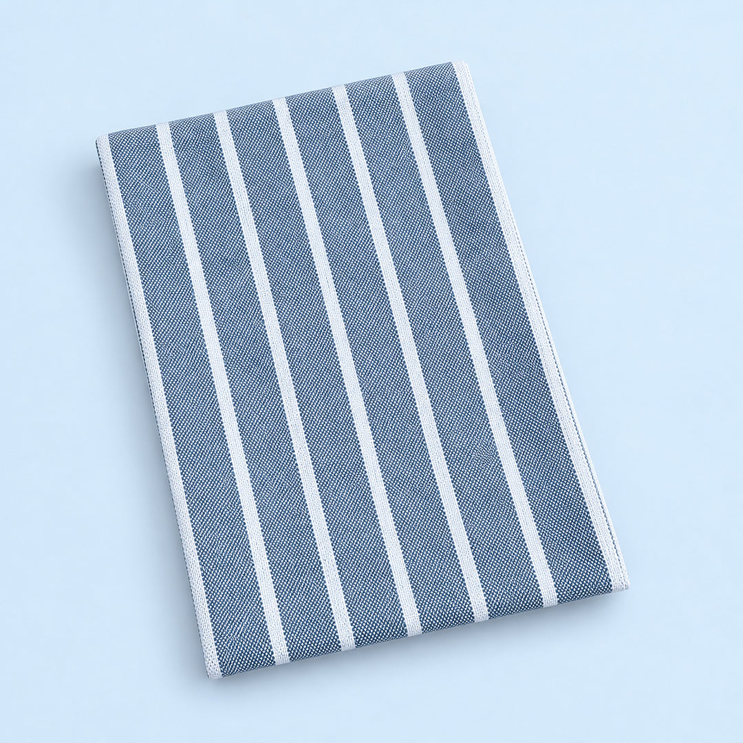 Single blue stripes cotton towel, folded studio view.