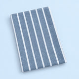 Single blue stripes cotton towel, folded studio view.