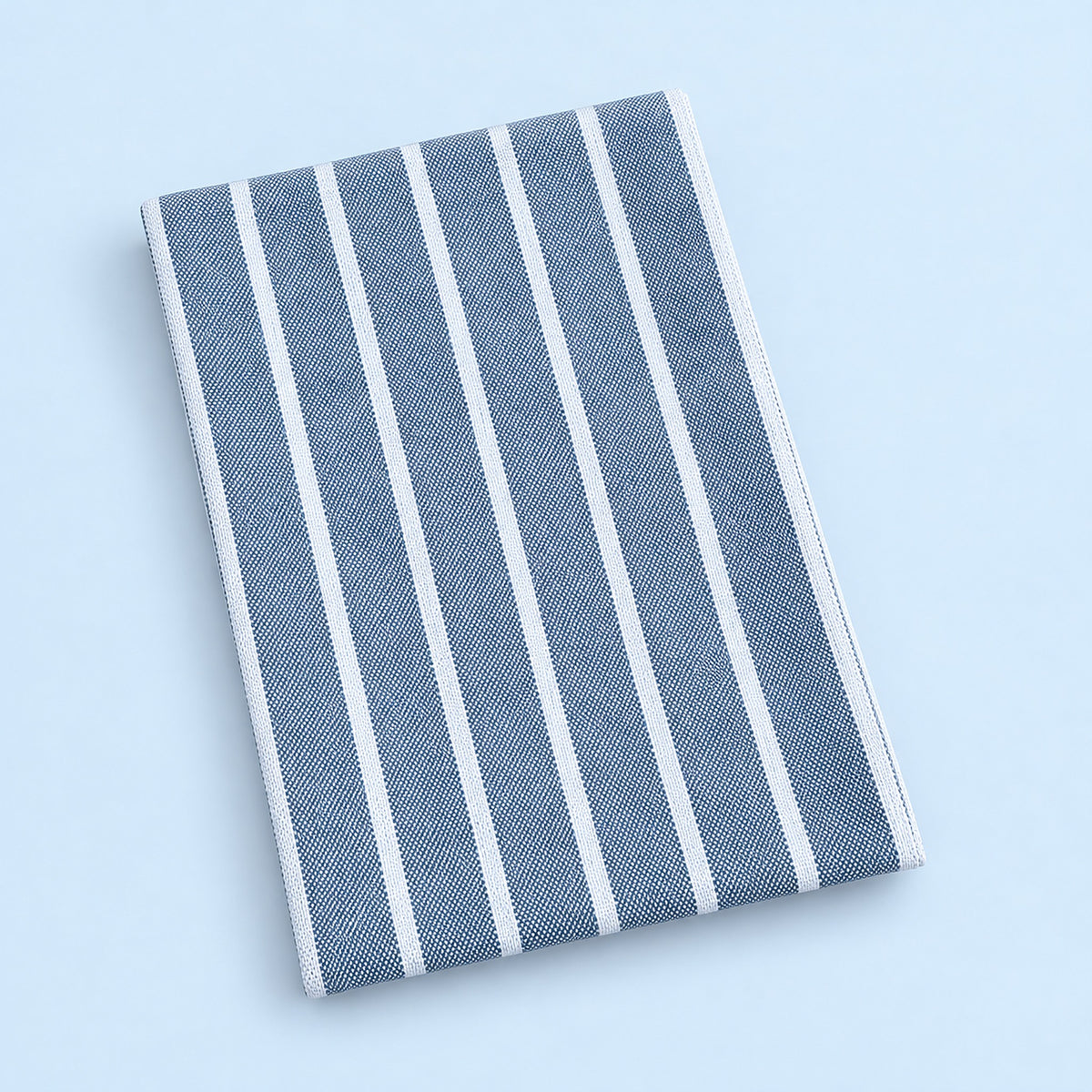 Single blue stripes cotton towel, folded studio view.