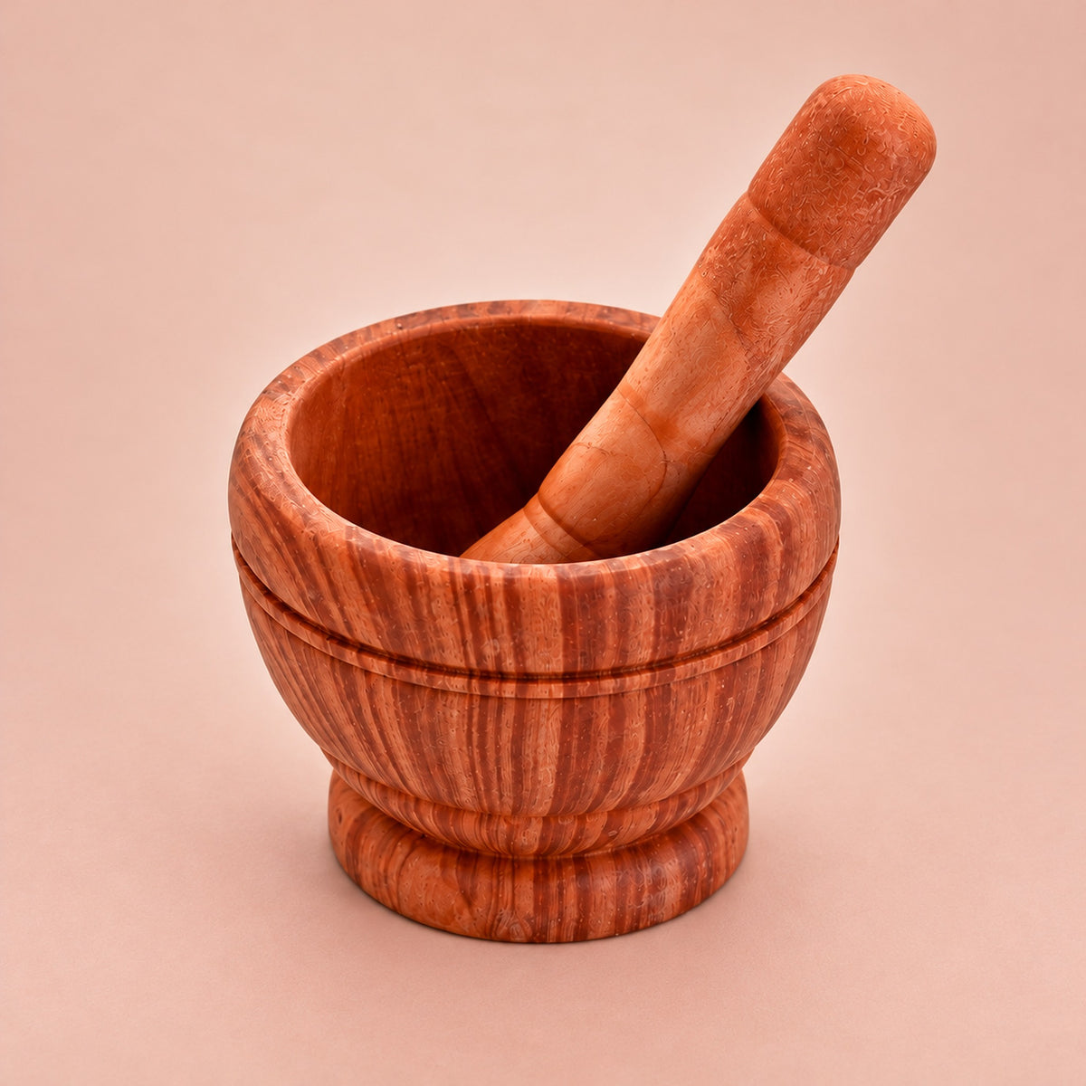 Dark Brown variant: one brown patterned mortar and matching pestle on a lighter warm studio background.