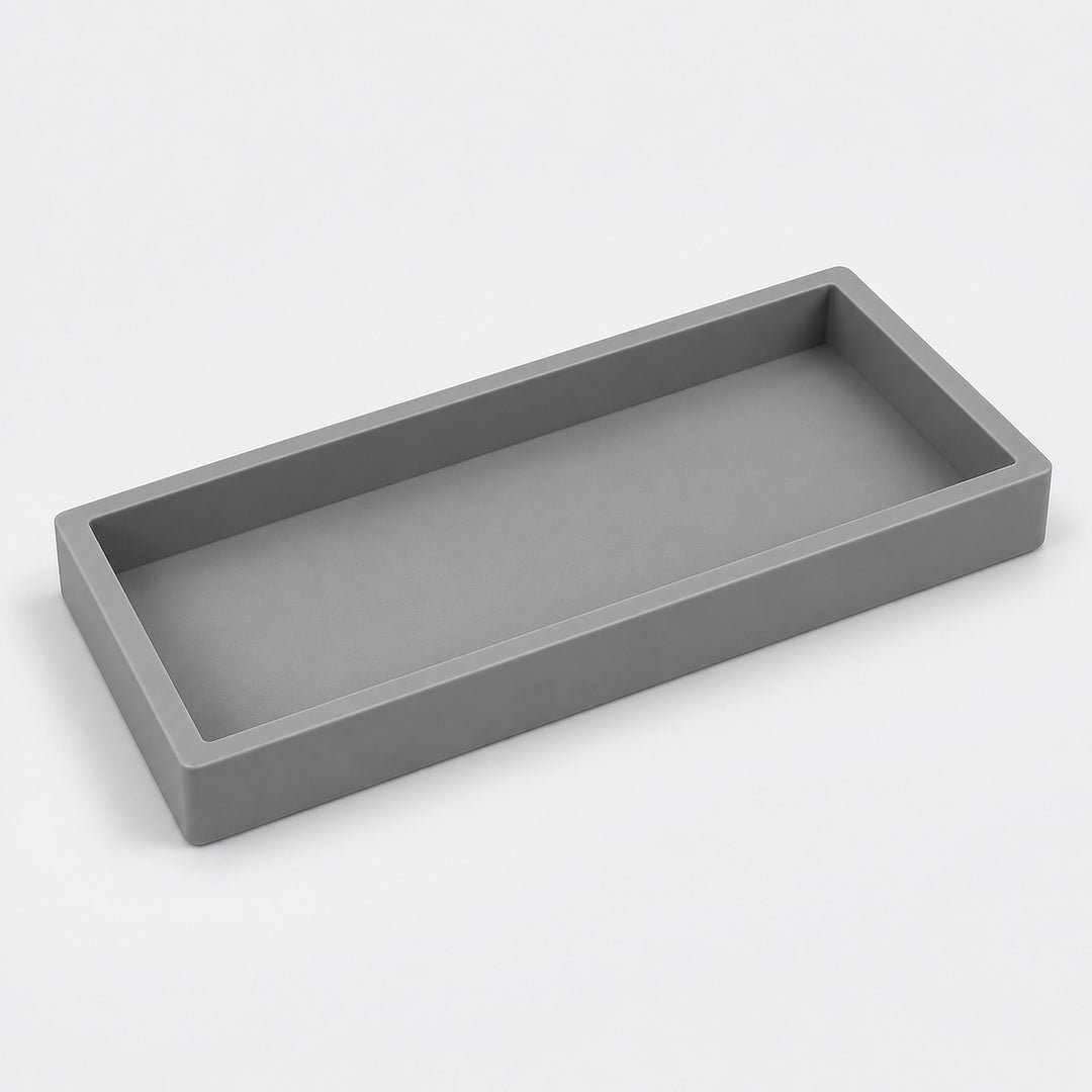 A minimalist rectangular tray with a matte gray finish, shown from an elevated perspective on a clean white background.