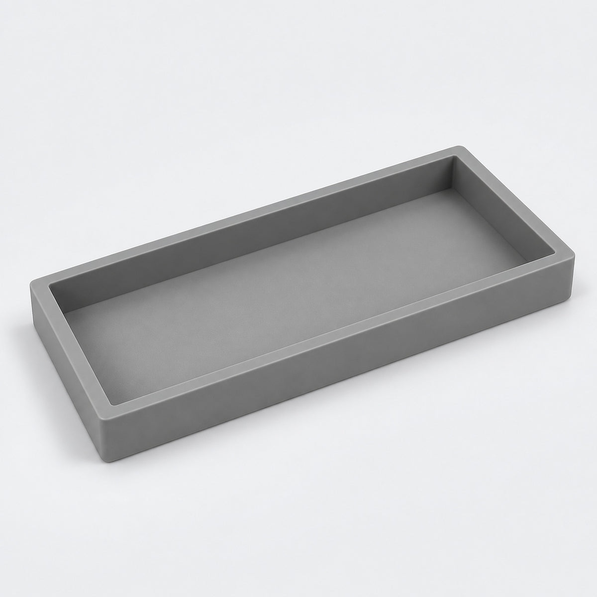 A minimalist rectangular tray with a matte gray finish, shown from an elevated perspective on a clean white background.
