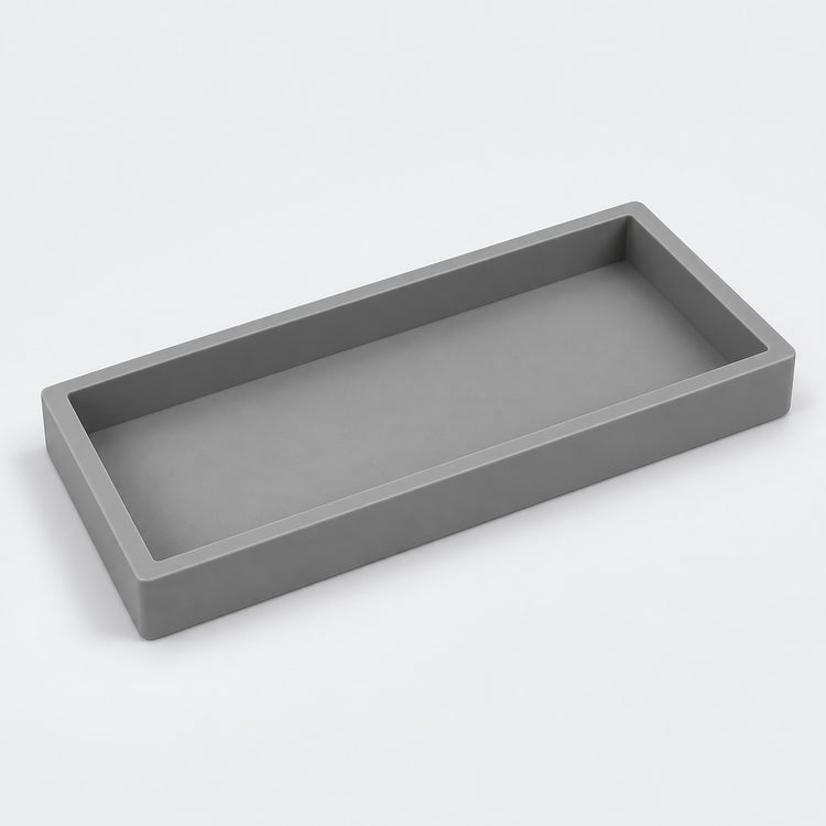A minimalist rectangular tray with a matte gray finish, shown from an elevated perspective on a clean white background.