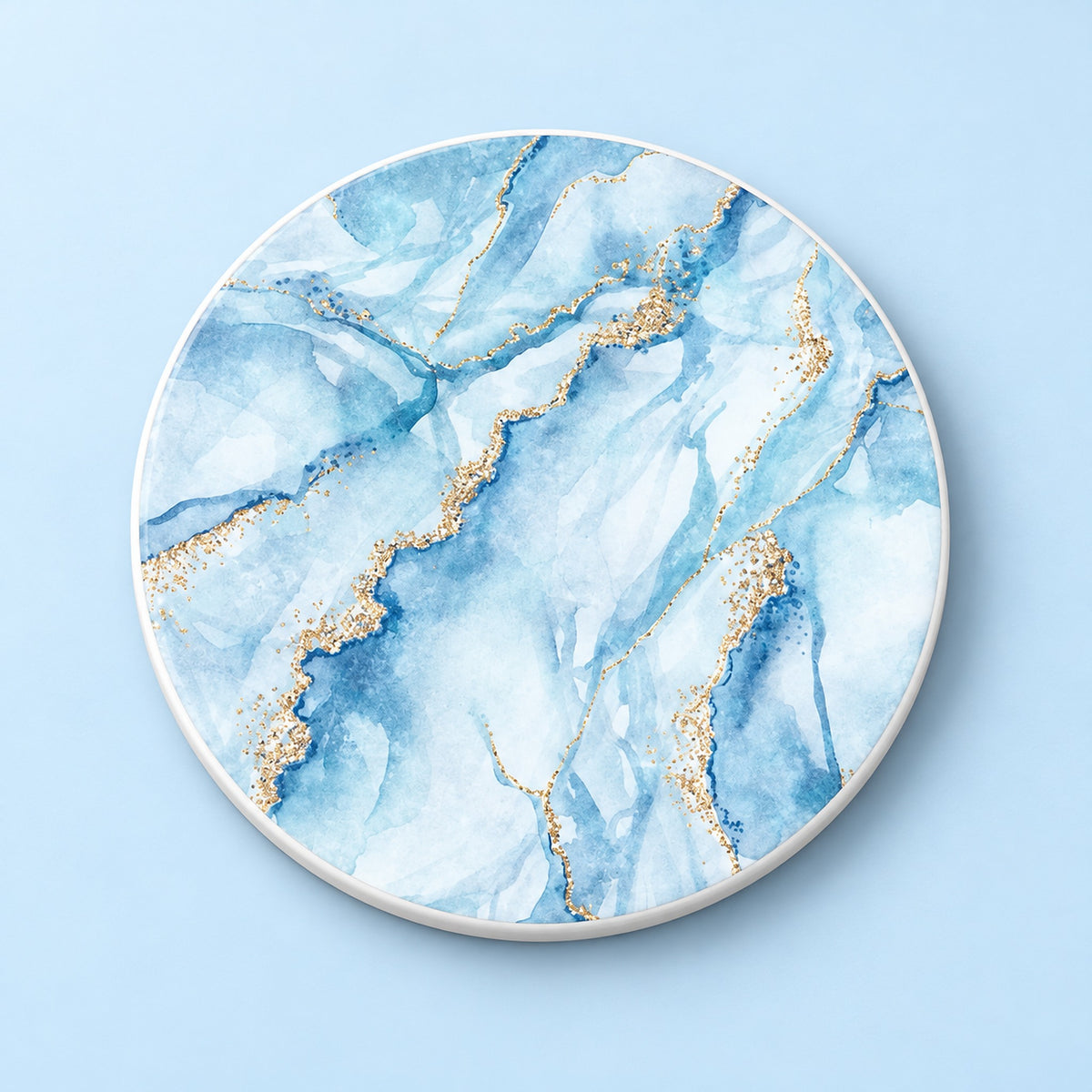 One light blue and gold marble printed ceramic coaster on a light studio background.