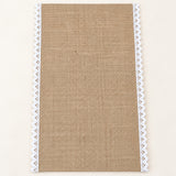 One tan placemat with white scalloped trim, 30 x 45 cm.