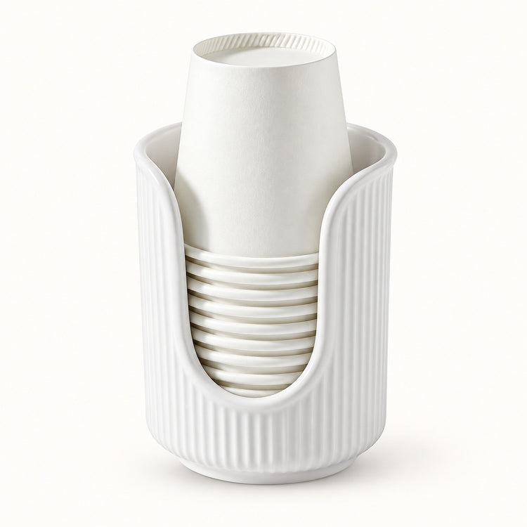 A white ribbed cup holder cradling a stack of white paper cups, photographed against a seamless white background.