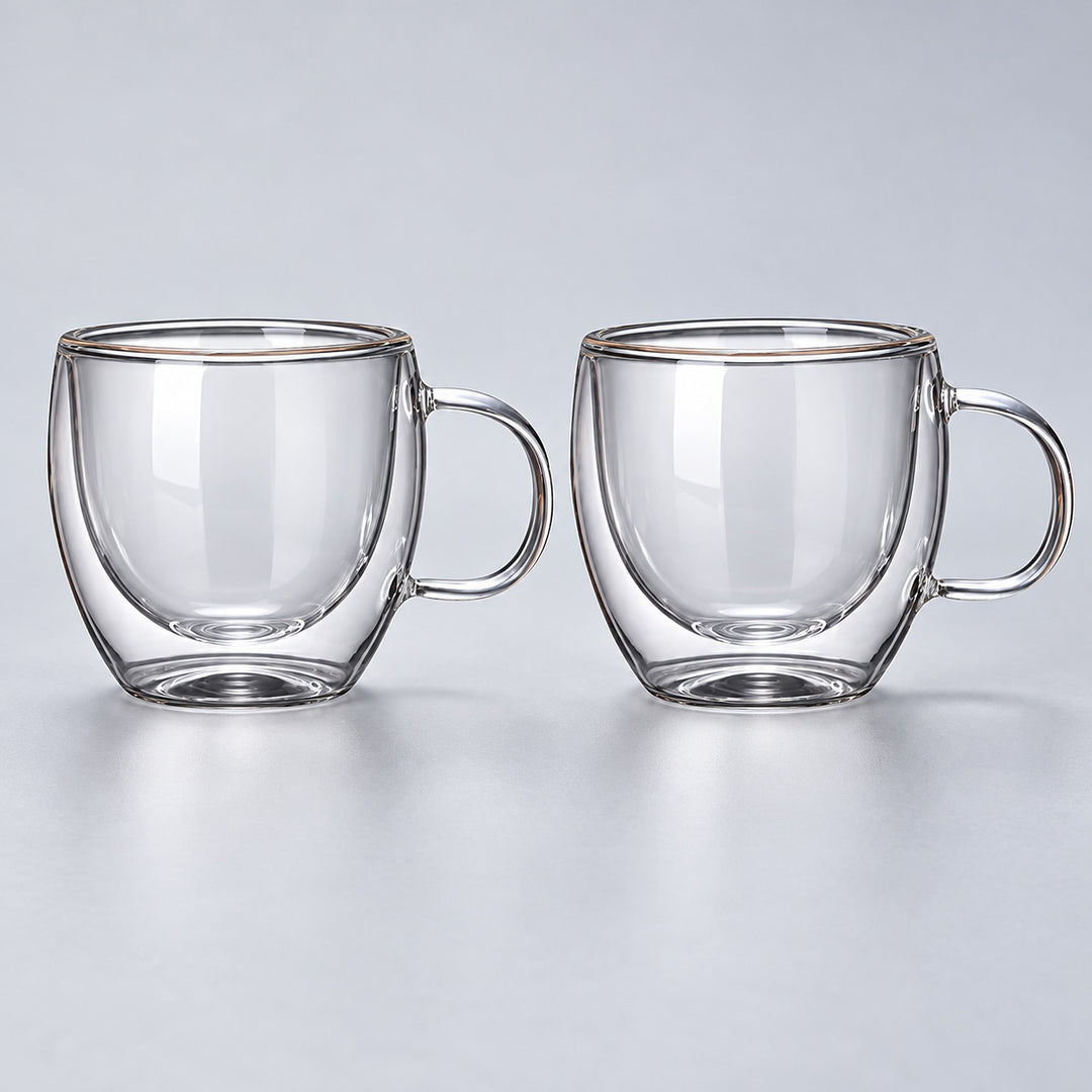Two empty small 150 ml clear double-wall glass mugs with handles.