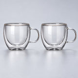 Two empty small 150 ml clear double-wall glass mugs with handles.