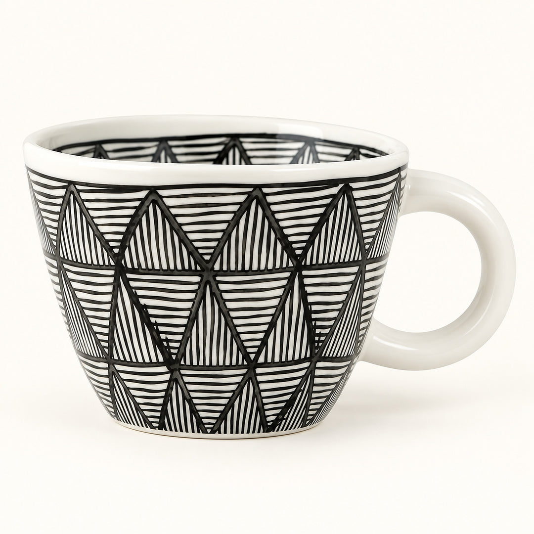 A white ceramic coffee mug with a black hand-drawn geometric triangle pattern, shown on a clean white background.