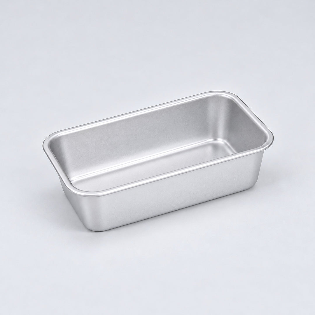 Empty silver aluminum loaf pan, 13.8 x 8 x 3.8 cm.